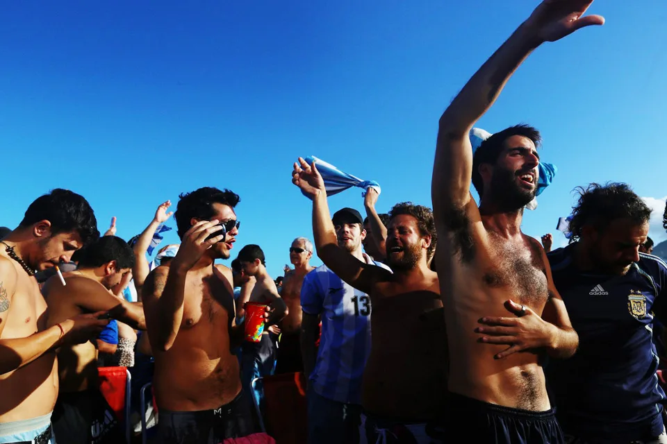 To cool off from the 30 degree heat many fans run into the water for a swim before the match begins